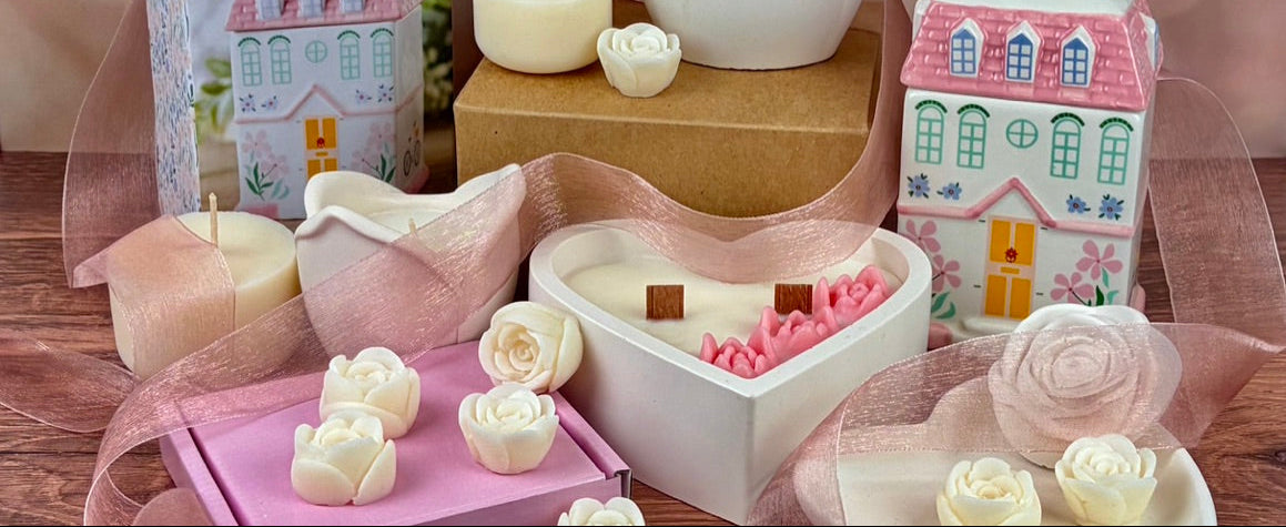 Decorative candles and ceramic items on a wooden surface with a soft, blurred background.